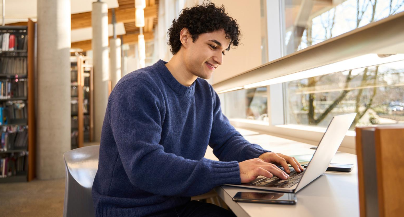College student using a laptop for programming and university coursework