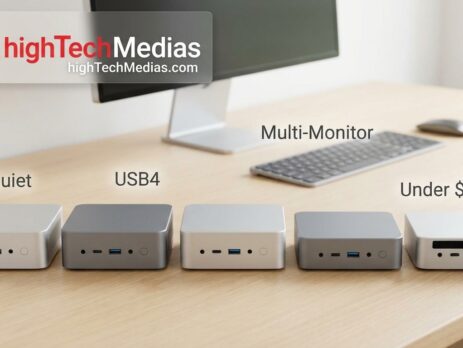 Five compact mini PCs in a row on a clean home-office desk with a monitor and keyboard
