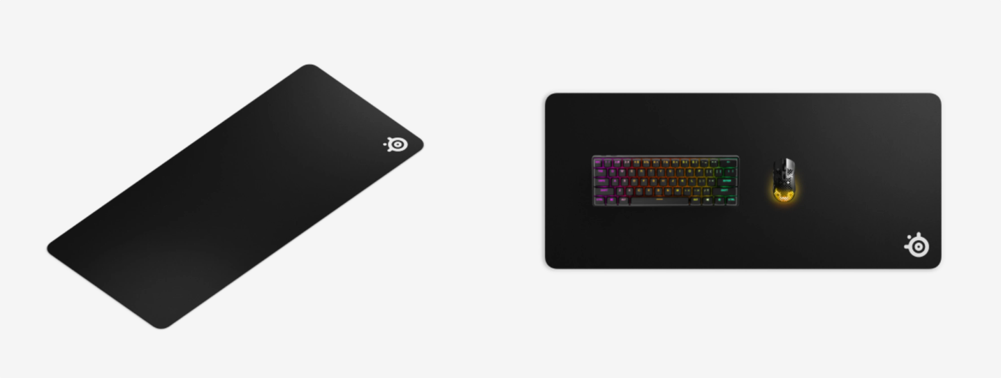 QcK cloth gaming mousepad with a wireless mouse on a PC gaming desk.